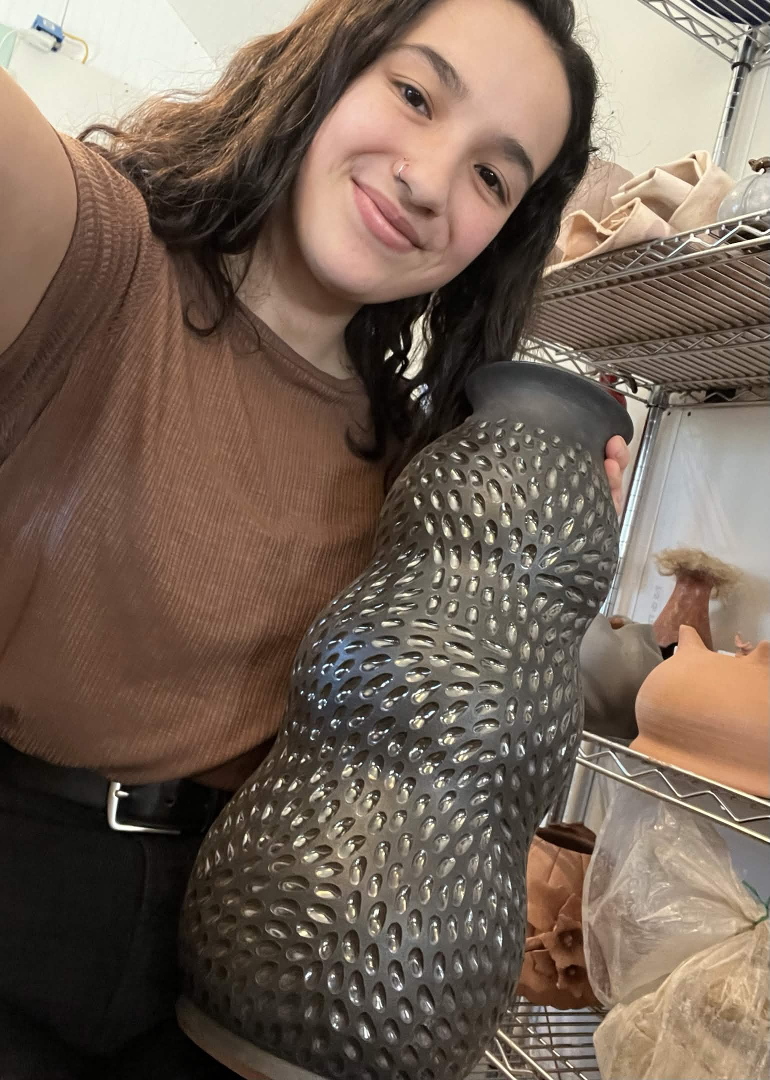 Jaida holding a large wheel-thrown vase that now lives in NYC